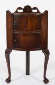 A Georgian mahogany bow-fronted corner bedside cabinet:,