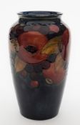 A Moorcroft pottery vase: of oviform, tube lined in the Pomegranate pattern in purple,