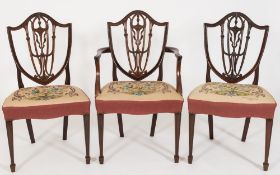 A set of eight late 19th Century carved mahogany dining chairs:, in the Hepplewhite taste,