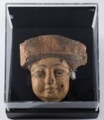 An Egyptian female wood mask from a sarcophagus: with traces of polychrome decoration,