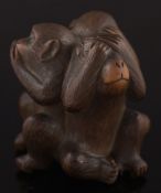 A Japanese carved boxwood okimono of three monkeys 'Hear no evil, See no evil,