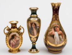 A group of three Vienna-style vases: of baluster form, one with foliate scroll handles,