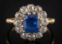 A cushion shaped sapphire and diamond cluster ring: with central cushion-shaped sapphire
