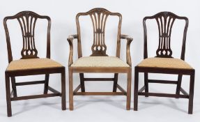 A set of eight late 19th Century carved mahogany dining chairs in the Hepplewhite taste:,