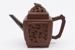 A Chinese Yixing teapot and cover: of square section moulded with panels of prunus,