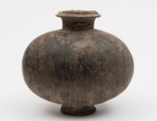 A Chinese pottery cocoon vase: the ovoid body incised with vertical geometric bands,