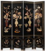 A Chinese hardstone and soapstone decorated black lacquer four-fold screen: with mother of pearl