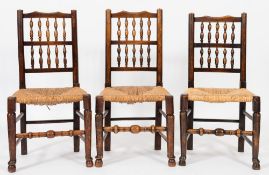 A harlequin set of eight late 18th/early 19th Century ash and fruitwood spindleback dining chairs:,