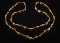 An early 19th century gold long chain necklace: of pierced tapering,