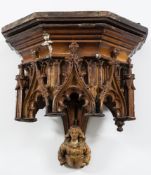 A 19th century Gothic carved oak wall bracket: the moulded pediment with blind arched arcaded