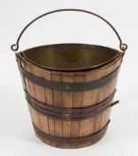 A teak and brass bound swing handled elliptical bucket:,