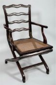 Campaign Furniture An early 19th Century mahogany ladderback campaign folding armchair:,