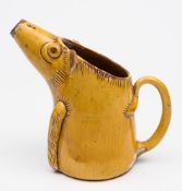 A late 19th/early 20th century Ewenny novelty pottery pig jug: slip glazed in ocre,