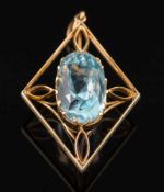 A yellow metal and oval blue topaz single stone pendant: the oval blue topaz approximately 19.