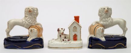 An opposing pair of Staffordshire spaniel inkwells and a similar group: the former in standing pose
