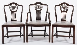A set of six carved mahogany dining chairs:, in the Hepplewhite taste,