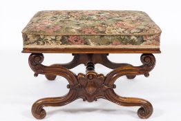 A Victorian carved walnut curved X-frame stool: with upholstered machined tapestry stuff over seat