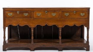 A late 18th / early 19th century oak rectangular dresser base: the top with a reeded moulded edge,