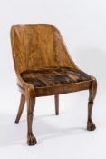 A Continental satinwood salon chair: with solid carved arched back and bowed seat upholstered in