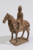 A Chinese painted pottery horse and rider: standing four-square,