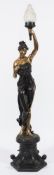 A 20th century brass and bronzed torchiere lamp in the form of a semi-nude female: holding a torch