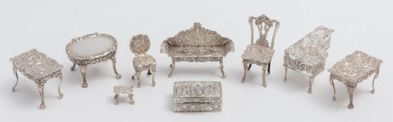 A collection of miniature silver furniture, various makers and dates: including a piano, tables,