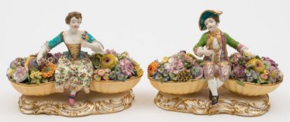 A pair of Minton figures of flower sellers: in the form of a youth and girl in 18th century costume,