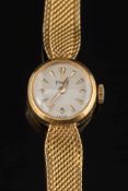 A lady's 18ct gold 'Piaget' wristwatch: the circular dial with tapered baton markers and on 18ct