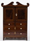 An apprenticeman's early 19th century mahogany and inlaid linen press: bordered with sycamore lines,