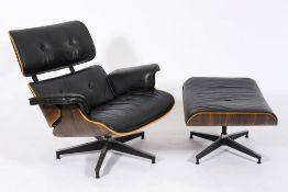 A coromandel finish and black vinyl button back armchair: in the style of Eames on blackened finish