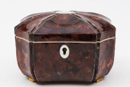 A 19th century tortoiseshell tea caddy: of rectangular outline, with recessed canted corners,