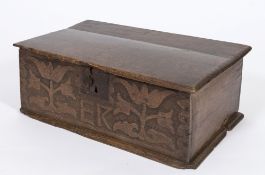 An early 18th century oak rectangular bible box: with a plain hinged top and blind fret carved