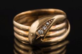An 18ct gold and diamond mounted three-stone 'snake' ring: the head inset with graduated stones,