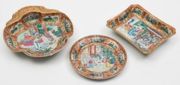 A group of three Chinese Canton famille rose dishes: painted with panels of insects, birds,