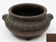 A Chinese bronze tripod censer: of compressed circular form,