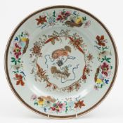 A Chinese famille rose porcelain charger: the centre enamelled with a pair of shi shi and two