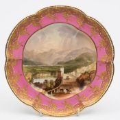 A Coalport porcelain cabinet plate: of lobed circular form the centre finely painted with a view of