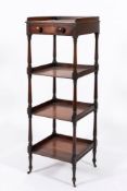 An early 19th century mahogany four-tier whatnot: with a three quarter ledge gallery and single