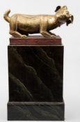 A large Thai gilt-bronze figure of a goat: in crouching pose with head turned to the right,