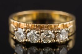 An 18ct gold and diamond four-stone ring: with circular,