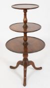 A mid 18th Century mahogany circular three-tier graduated dumb waiter:,