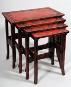 A set of Japanese red lacquer quartetto tables: the rectangular tops carved with a border of bamboo