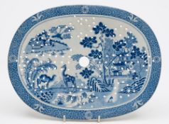 Two unattributed pearl glazed transfer decorated blue and white strainers: of oval form one in the