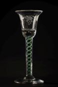 A colour twist wine glass: the bell shaped bowl with a row of basal tears engraved with an