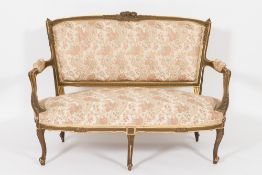 A French carved giltwood salon suite:, comprising a canape,