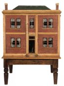 An early 19th century large painted pine dolls house: with green painted simulated tiled pitched