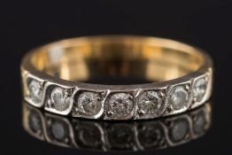An 18ct gold and diamond seven-stone ring: with circular,