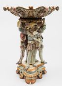 A Hugo Lonitz majolica figural comport of generous proportions: modelled with three figures in