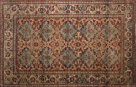 An Isfahan rug:, the field with shaped lozenge panels in beige and pastel blue colours,