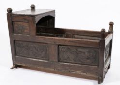 A 17th century carved oak cradle: with a plain canopy,